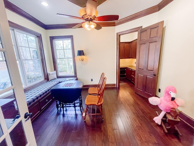 office featuring dark wood-type flooring, crown molding, baseboards, and ceiling fan