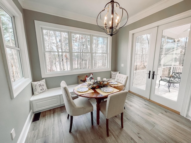 dining space featuring baseboards, french doors, ornamental molding, light wood-type flooring, and breakfast area