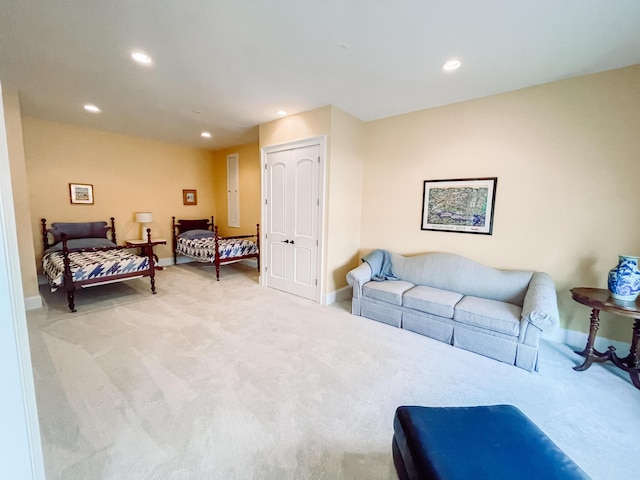 living area featuring baseboards, light colored carpet, and recessed lighting