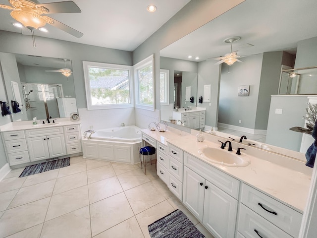 bathroom featuring a stall shower, two vanities, a sink, and tile patterned floors