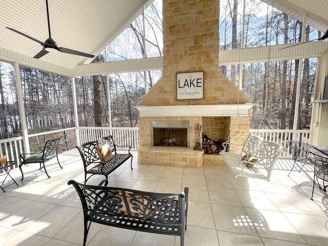 view of patio featuring ceiling fan and an outdoor stone fireplace