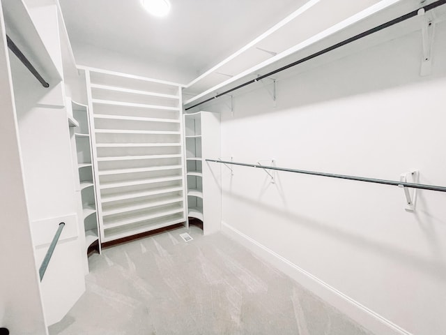 walk in closet featuring carpet flooring