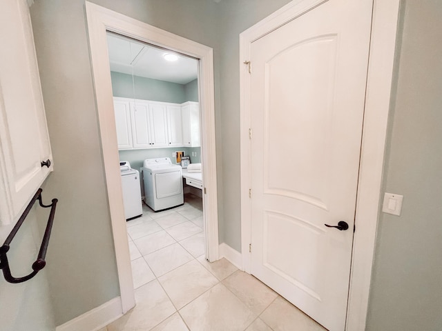 hall featuring attic access, baseboards, separate washer and dryer, and light tile patterned flooring