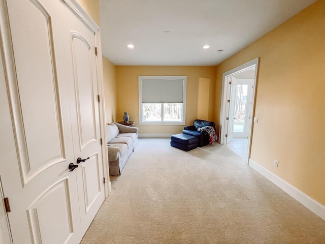 living area with baseboards, recessed lighting, and light colored carpet