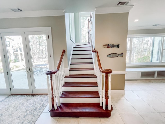 stairs with french doors, tile patterned flooring, visible vents, and a healthy amount of sunlight