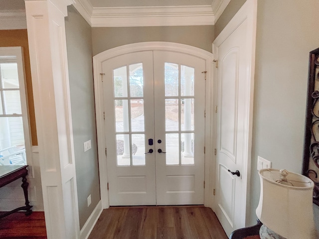 entryway featuring dark wood-type flooring, french doors, crown molding, and ornate columns