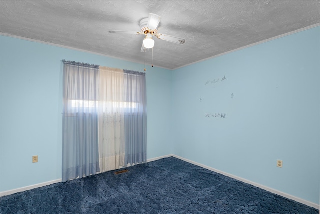 carpeted spare room featuring a textured ceiling, ceiling fan, and crown molding