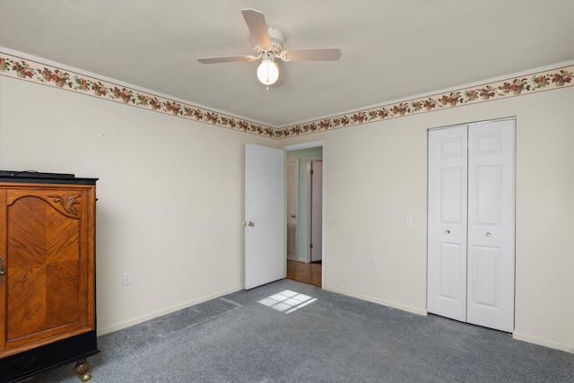 unfurnished bedroom featuring ceiling fan, a closet, and dark carpet