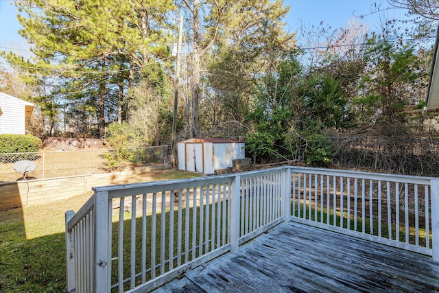 deck with a lawn and a storage shed