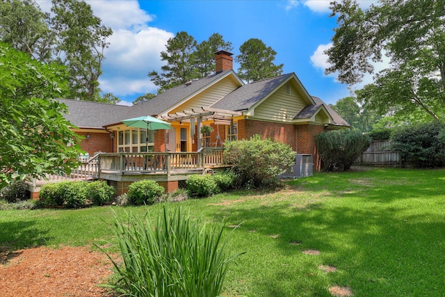 213 Oak Ln, Waynesboro, GA 30830 - back of property featuring brick siding, a deck, a chimney, and a pergola
