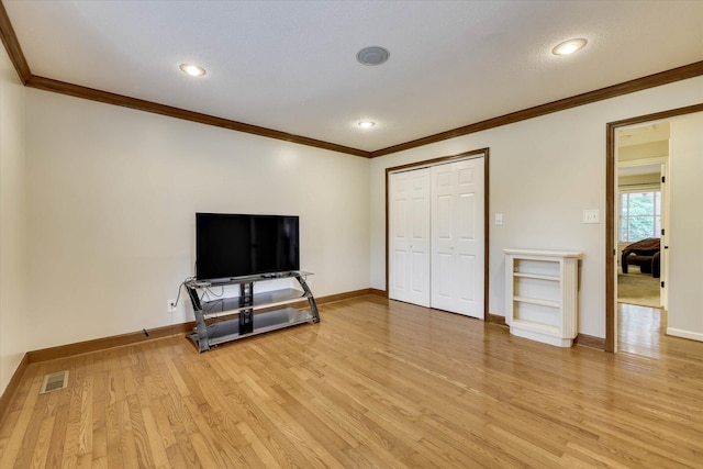 213 Oak Ln, Waynesboro, GA 30830 - unfurnished living room with crown molding, light wood-style floors, baseboards, and recessed lighting