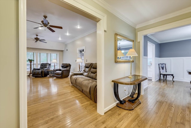 213 Oak Ln, Waynesboro, GA 30830 - living room featuring light wood-style floors, ceiling fan, and ornamental molding