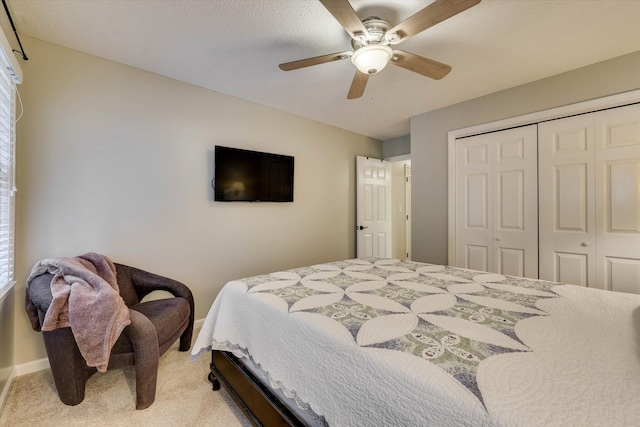213 Oak Ln, Waynesboro, GA 30830 - bedroom with light carpet, a closet, a ceiling fan, and baseboards