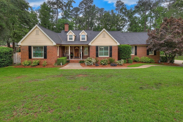 213 Oak Ln, Waynesboro, GA 30830 - cape cod home featuring brick siding, a chimney, and covered porch