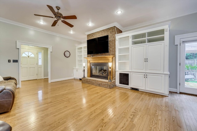 213 Oak Ln, Waynesboro, GA 30830 - living area featuring ornamental molding, a ceiling fan, baseboards, light wood-style flooring, and a brick fireplace
