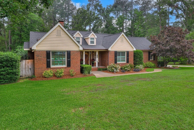 213 Oak Ln, Waynesboro, GA 30830 - cape cod house featuring brick siding, a chimney, a shingled roof, and covered porch