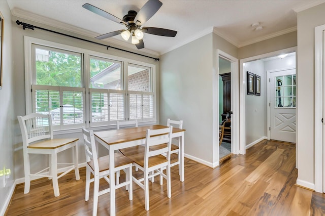 213 Oak Ln, Waynesboro, GA 30830 - dining area featuring light wood-style floors, ornamental molding, baseboards, and a ceiling fan