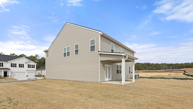 exterior space with a yard, a patio area, and central AC