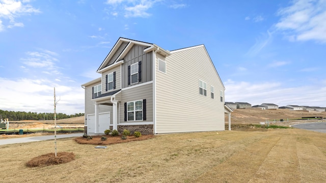 view of home's exterior featuring a garage, brick siding, board and batten siding, and concrete driveway