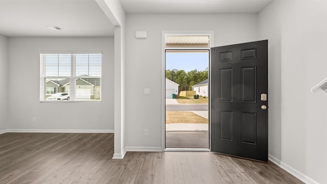 entryway with visible vents, wood finished floors, and baseboards