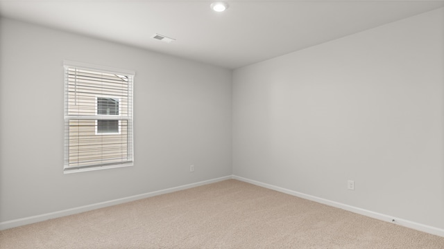 spare room with visible vents, baseboards, and carpet floors