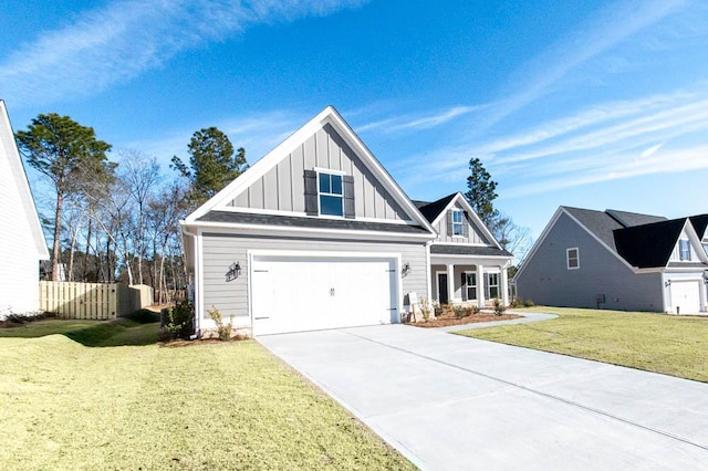 view of front facade with an attached garage, fence, driveway, board and batten siding, and a front yard