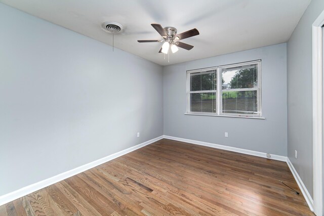 spare room with hardwood / wood-style flooring and ceiling fan