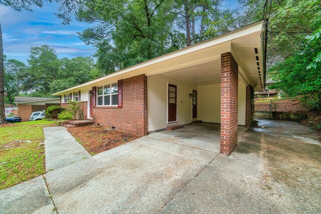 ranch-style house featuring a carport