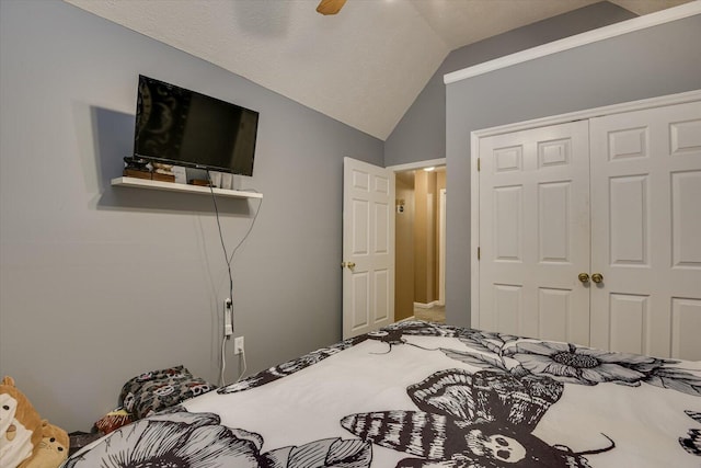 bedroom with a closet, vaulted ceiling, and ceiling fan