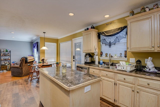 kitchen with crown molding, sink, wood-type flooring, dishwasher, and a kitchen island