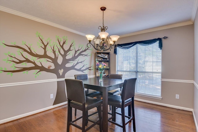 dining room featuring a chandelier, hardwood / wood-style floors, plenty of natural light, and crown molding