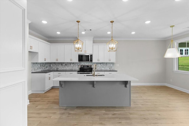 250 Prominence Dr, Grovetown, GA 30813 - kitchen with stainless steel microwave, range with electric stovetop, crown molding, decorative backsplash, and white cabinets