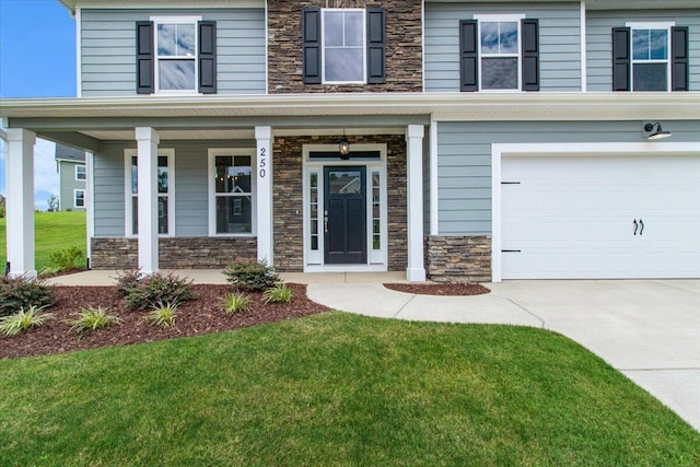 250 Prominence Dr, Grovetown, GA 30813 - entrance to property featuring stone siding, an attached garage, driveway, a porch, and a yard