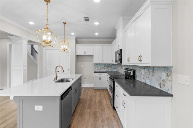 250 Prominence Dr, Grovetown, GA 30813 - kitchen featuring stainless steel appliances, a chandelier, crown molding, light wood-type flooring, and white cabinets