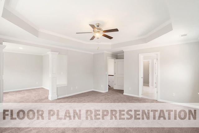 carpeted empty room with a tray ceiling, ceiling fan, and crown molding