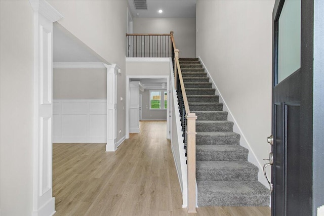 250 Prominence Dr, Grovetown, GA 30813 - entrance foyer featuring a high ceiling, light wood-type flooring, stairs, and ornate columns