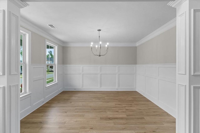 250 Prominence Dr, Grovetown, GA 30813 - unfurnished dining area featuring a decorative wall, a chandelier, light wood-style flooring, ornamental molding, and a wainscoted wall