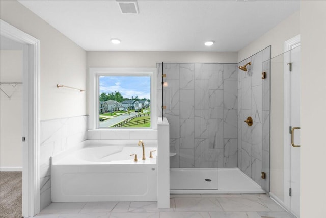 250 Prominence Dr, Grovetown, GA 30813 - bathroom featuring a bath, a marble finish shower, marble look tile flooring, recessed lighting, and a walk in closet
