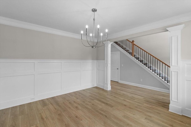 250 Prominence Dr, Grovetown, GA 30813 - unfurnished dining area featuring ornate columns, a decorative wall, crown molding, a chandelier, and stairway
