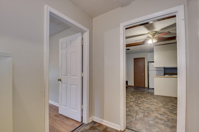 corridor featuring a textured ceiling