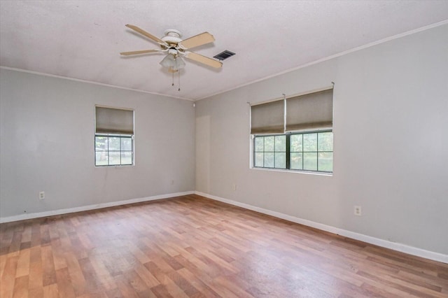 unfurnished room with a healthy amount of sunlight and ornamental molding