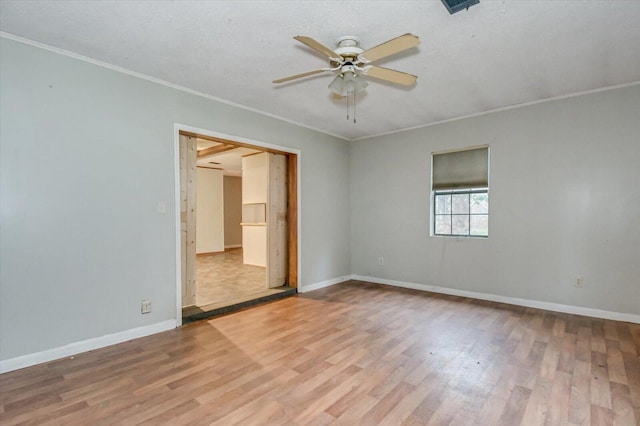 empty room with ceiling fan, ornamental molding, and light hardwood / wood-style flooring