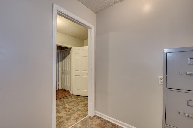 hallway featuring a textured ceiling