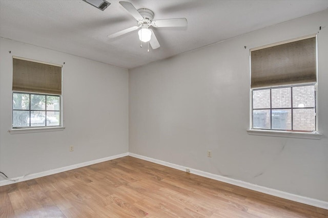 empty room featuring ceiling fan and light wood-type flooring