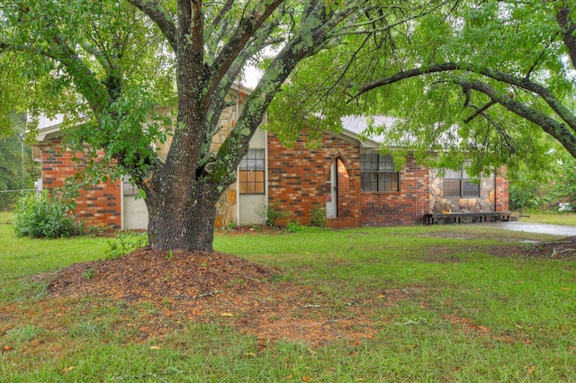 view of side of home with a yard