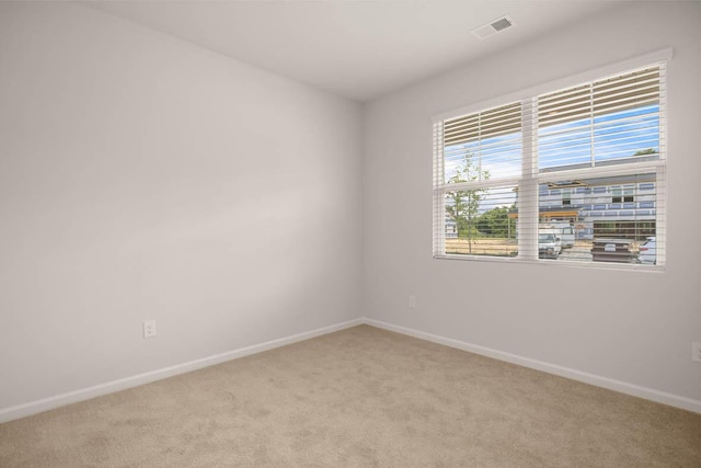 unfurnished room with light carpet