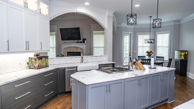 902 Adderley Ln, Evans, GA 30809 - kitchen with a sink, decorative backsplash, stainless steel gas cooktop, white cabinetry, and light stone counters