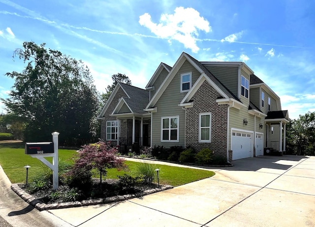 craftsman-style house with an attached garage, driveway, brick siding, and a front yard