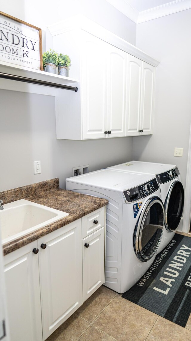 902 Adderley Ln, Evans, GA 30809 - washroom featuring cabinet space, independent washer and dryer, light tile patterned flooring, and ornamental molding