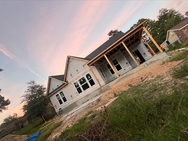 view of back house at dusk